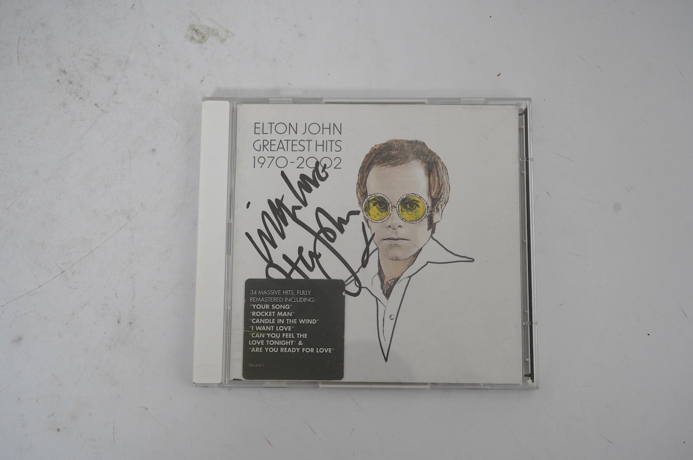 A signed Elton John CD; Greatest Hits 1970-2002, signed to the cover of the booklet in black ink, purchased at charity auction from Rachael Watkyns of the Tiny Box Company as a fundraiser to support makers of fair trade